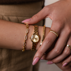Close up of a model showcasing a stylized look with our Cobblestone Timepiece watch, cube bracelet and pave linked bracelet.