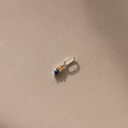 Silver Dainty Duo Birthstone Charm with topaz and sapphire. The design features two birthstones stacked vertically in prong setting with a large jump ring attached to the top. 