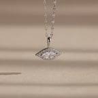 Silver Pave Evil Eye Charm hanging from a silver mirror chain