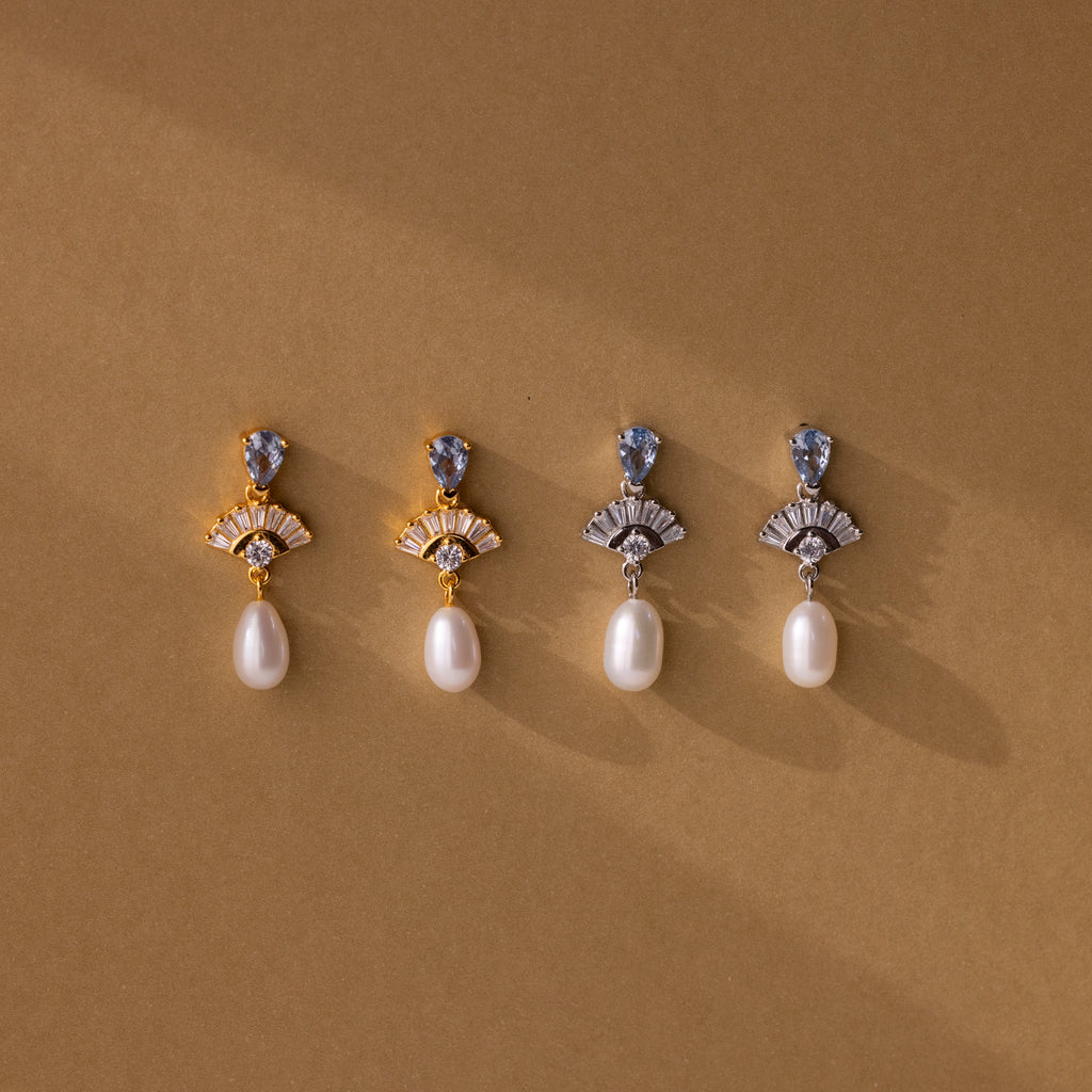 Four Aquamarine Pearl Drop Earrings in 18K Gold displayed on a brown background with soft shadows—perfect wedding earrings that embody timeless vintage glamour.