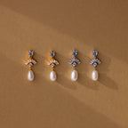 Four Aquamarine Pearl Drop Earrings in 18K Gold displayed on a brown background with soft shadows—perfect wedding earrings that embody timeless vintage glamour.