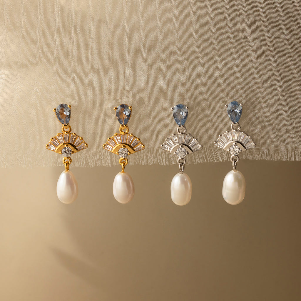 Add vintage glamour to any look with these Aquamarine Pearl Drop Earrings in 18K Gold—perfect for weddings or for adding classic style, they beautifully complement light fabrics.