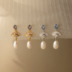 Add vintage glamour to any look with these Aquamarine Pearl Drop Earrings in 18K Gold—perfect for weddings or for adding classic style, they beautifully complement light fabrics.