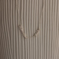 Carrie Multiple Name Necklace with Hanna and Pablo on a textured, light background—a perfect personalized jewelry piece.