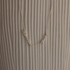 Carrie Multiple Name Necklace with Hanna and Pablo on a textured, light background—a perfect personalized jewelry piece.