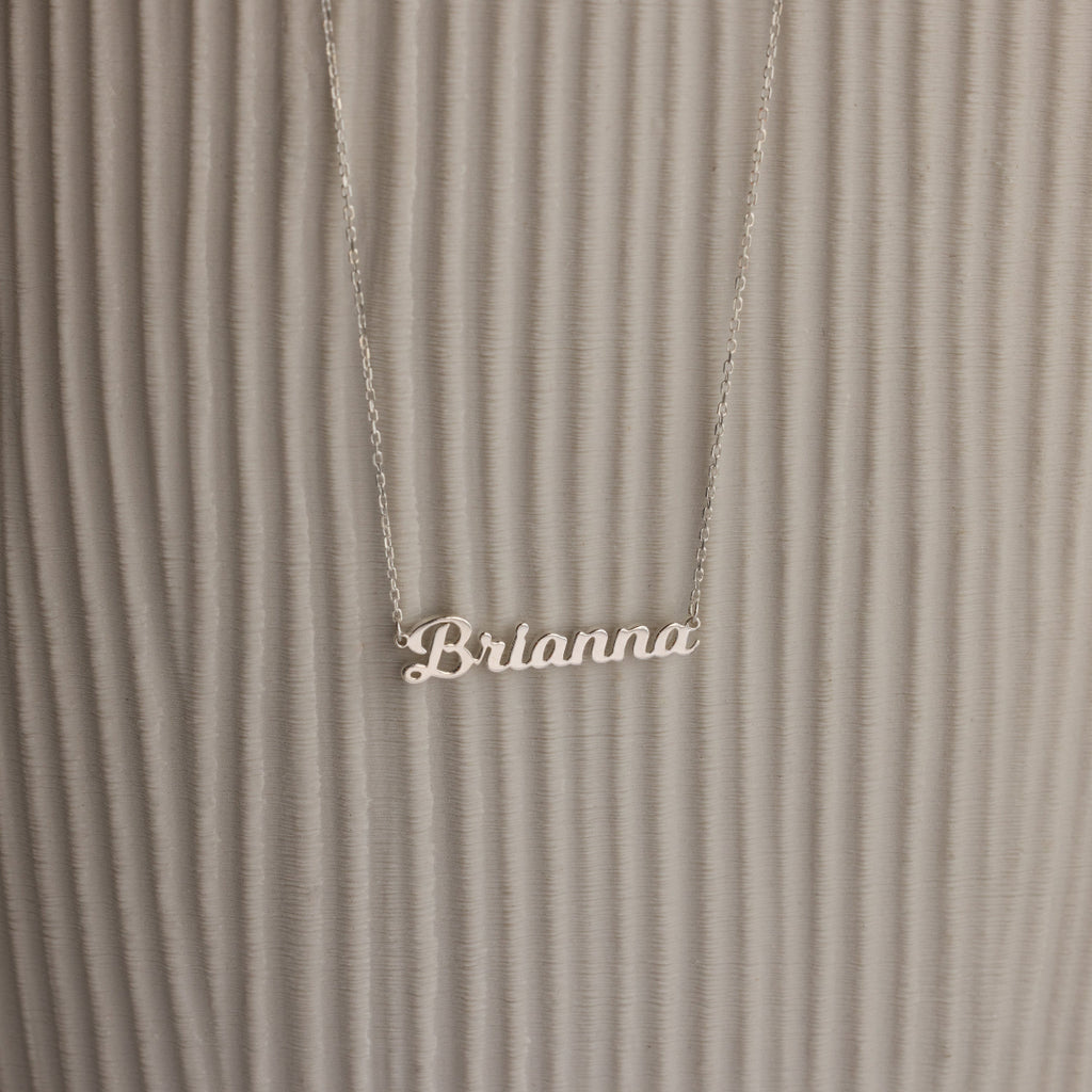 Mellow Name Necklace with "Brianna" shown on a textured, light background—a stylish personalized necklace for any occasion.