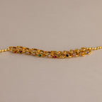 Floating Birthstone Huggies look stunning when paired with a gold chain bracelet featuring multicolored gemstones, creating a personalized jewelry statement on a neutral background.
