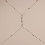 Detailed shot of the silver version of the body chain against a neutral background, featuring the fine chainwork and diamond details.