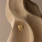 Flatlay of our Handwriting Heart Locket Necklace in Gold with the message "Always in my heart" engraved