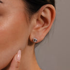 Close-up of a woman's ear wearing Rope Knot Studs in Silver; her finger touches her chin, showcasing the elegant, round silver earrings—perfect minimalist jewelry for any occasion.