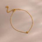 Close up of bubble initial bracelet in gold with the letter B.