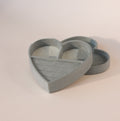 Mint green velvet heart-shaped jewelry box with lid, featuring ring slots and compartments on a neutral background.