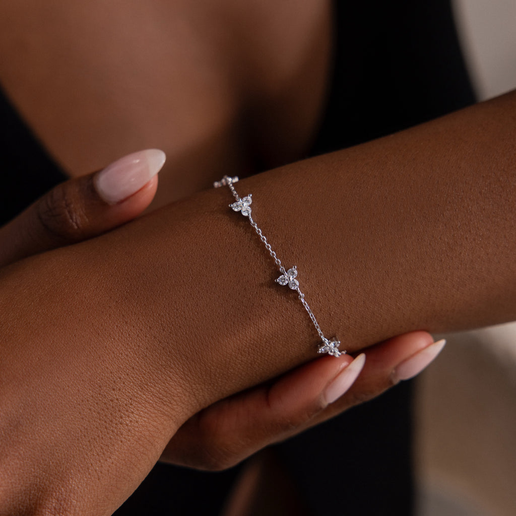 Silver diamond bracelet on a wrist with a blurred background