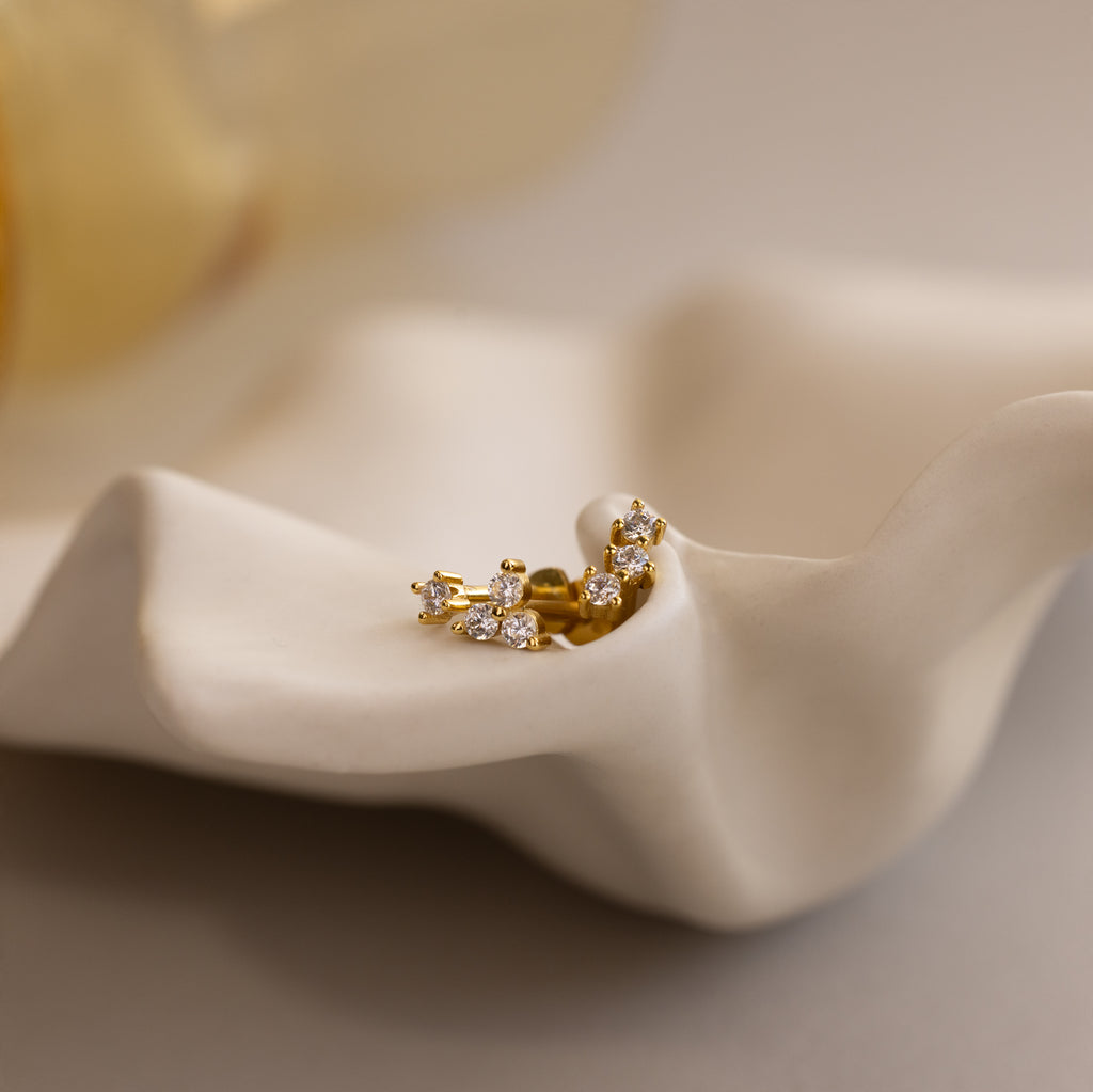 Set of 3 dainty gold round CZ Diamond Constellation Stud Earrings displayed in a ceramic dish