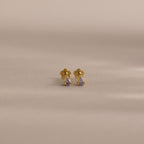 Teardrop Alexandrite Flatback Studs with small purple gemstones, displayed on a light beige background—ideal for those seeking elegant birthstone jewelry.