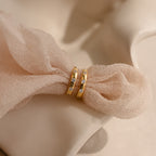 Mini Diamond Sprinkle Huggies in 18K Gold, featuring small diamonds, displayed on soft beige fabric.