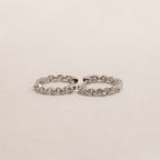 The Inside Out Diamond Huggies in Sterling Silver are hoop earrings adorned with a row of shimmering diamonds set in bright sterling silver.
