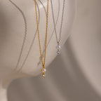 The Pearl Diamond Drop Necklace in 18K Gold, featuring pearl and diamond pendants, is displayed on a white mannequin bust—an elegant choice for bridal jewelry.