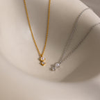 The Pearl Diamond Drop Necklace in Silver features a delicate pearl and sparkling gemstone, making it an elegant choice for bridal jewelry or as a stunning drop necklace displayed on any smooth surface.