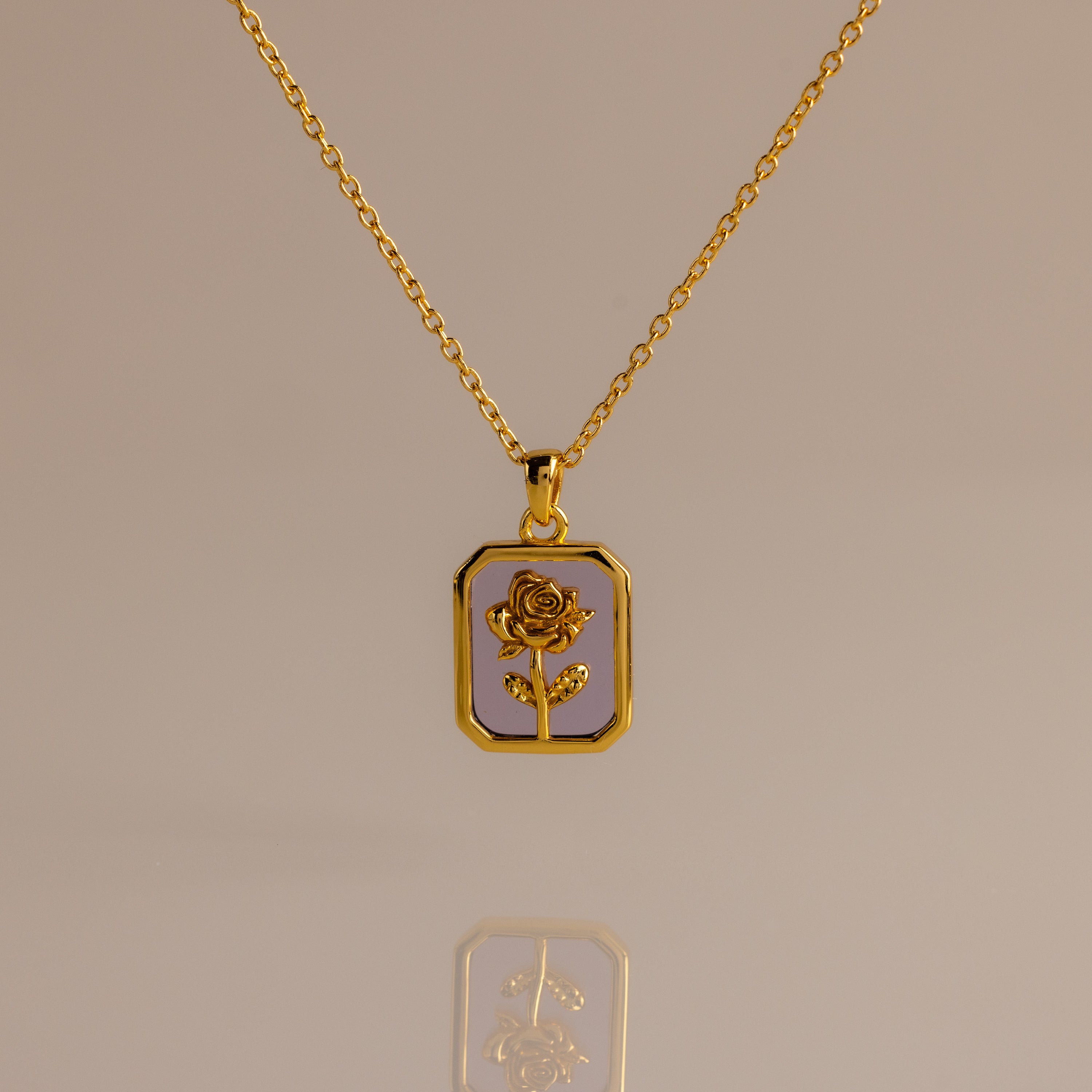 The Alexandrite Birth Flower Charm Necklace features a rectangular pendant with a rose design, making it ideal for layering or adding a subtle romantic touch to your style.