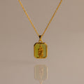 Peridot Birth Flower Charm Necklace with a rectangular pendant and raised floral design, ideal for elegant jewelry lovers and gift ideas, shown on a neutral background.