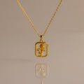 Opal Birth Flower Charm Necklace with a rectangular pendant featuring a flower design, displayed on a plain background.