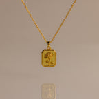 Topaz Birth Flower Charm Necklace featuring a rectangular pendant engraved with a delicate flower, displayed on a neutral background—an elegant addition to any jewelry collection.