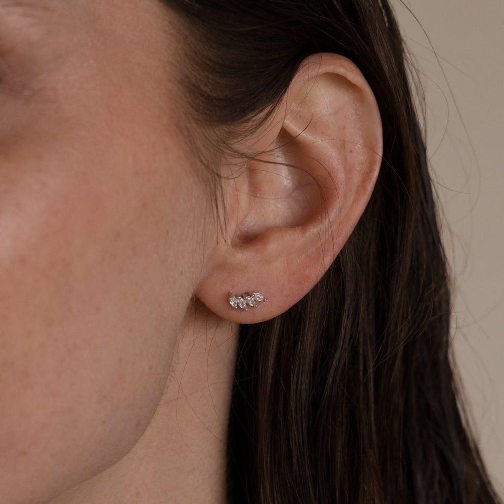 Close-up of a womans ear wearing Marquise Diamond Climbers in Silver, perfect as subtle wedding jewelry or paired with elegant diamond studs.