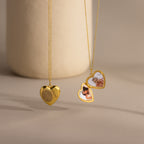 Flatlay showcasing the front and inside of our Fingerprint Heart Locket Necklace in Gold