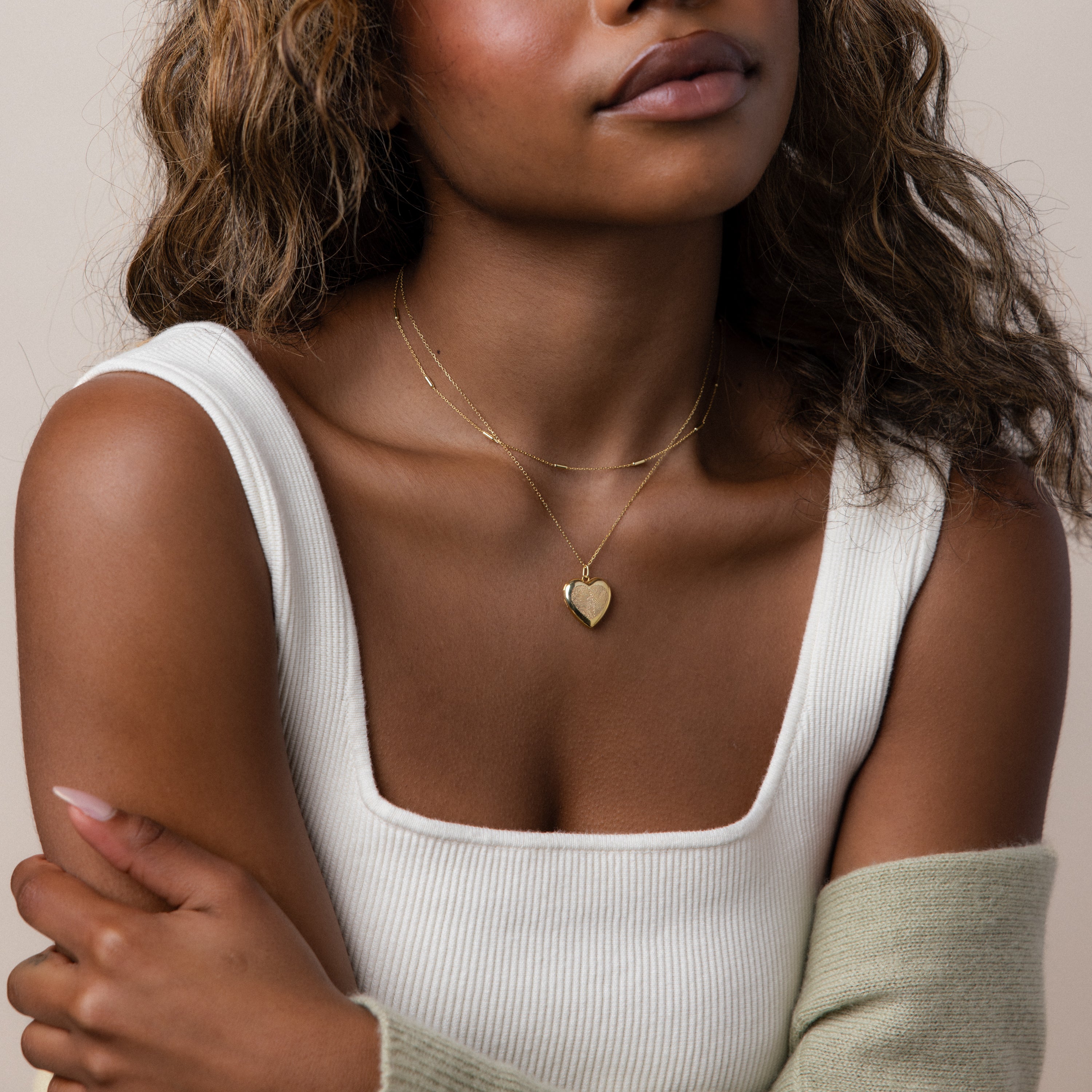 Model wearing our Fingerprint Heart Locket Necklace, styled with our Bar Station Necklace