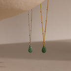 Two satellite chain necklaces in gold and silver, each featuring a single green jade teardrop gemstone pendant.
