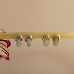 Two pairs of Jade Halo Drop Studs, one silver and one gold, featuring smooth green jade.