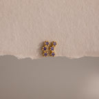Amethyst Cluster Flatback Studs featuring small purple gemstones are displayed on a textured beige surface.