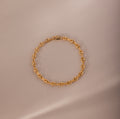 Mini Mariner Chain Bracelet in gold with rounded mariner-style links, placed on a neutral background.