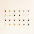 Twenty Raindrop Peridot Studs are arranged in five neat rows on a light background, each earring adding a vibrant touch to the elegant display.