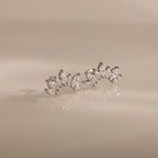 Marquise Diamond Arc Climbers in Silver, featuring marquise stones in a fan pattern, displayed on a beige reflective surface.