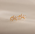 Marquise Diamond Arc Climbers in 18K Gold featuring leaf-shaped marquise stones arranged in a graceful arc, displayed on a neutral background.