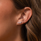 Close-up of a womans ear wearing Diamond Starfall Climbers in Silver, featuring delicate marquise cut gems arranged in a leaf-inspired design.