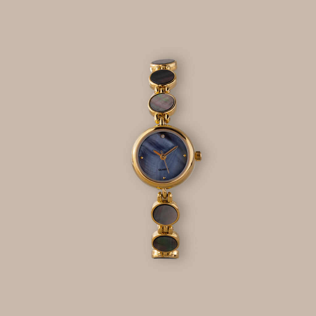 Gold-tone watch with blue mother of pearl dial and iridescent abalone links.