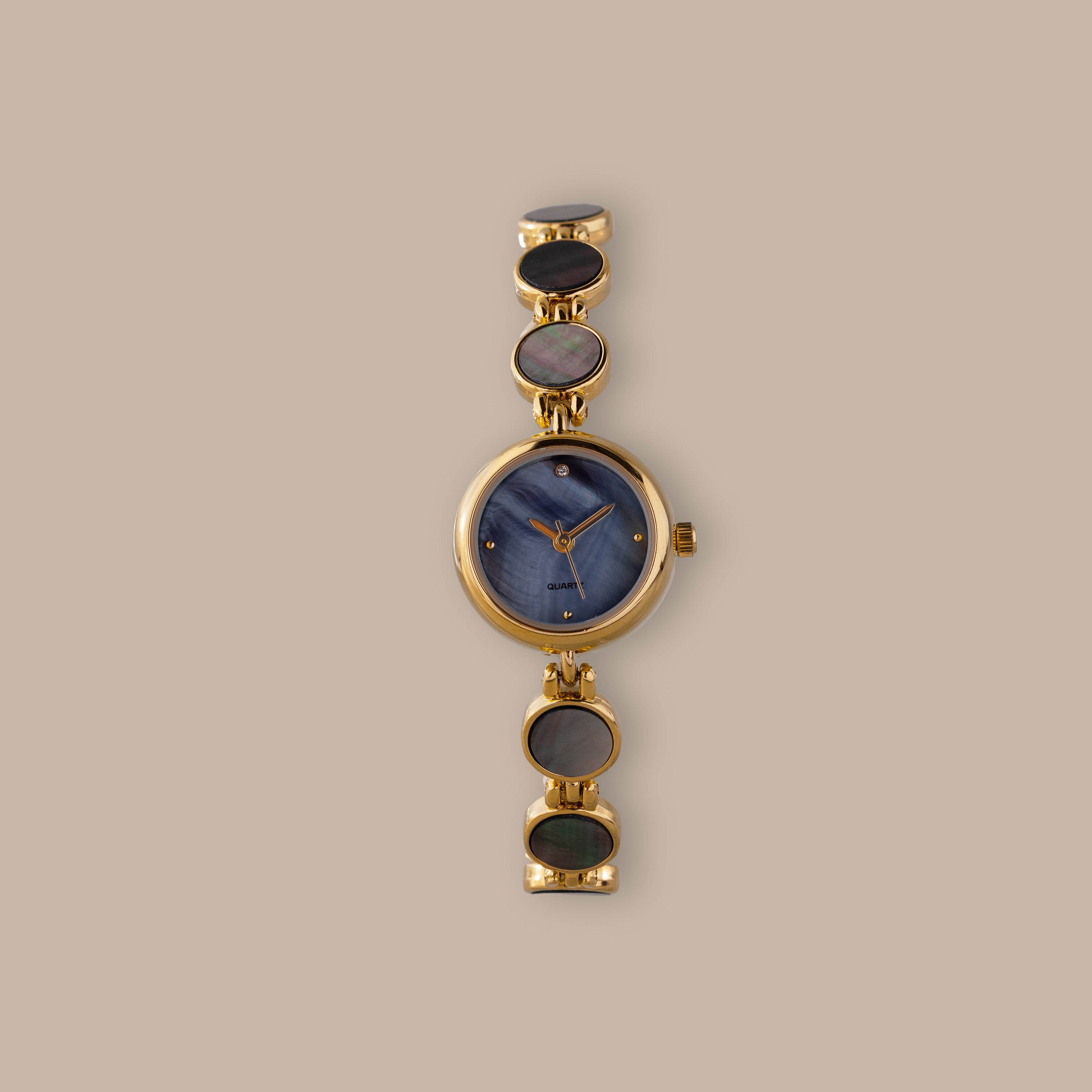 Gold-tone watch with blue mother of pearl dial and iridescent abalone links.