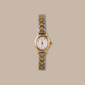 Balance Oval Link Timepiece: gold-tone watch with a minimalist dial and polished two-tone link bracelet.