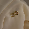 Chunky Ear Cuffs displayed on draped, cream-colored fabric.