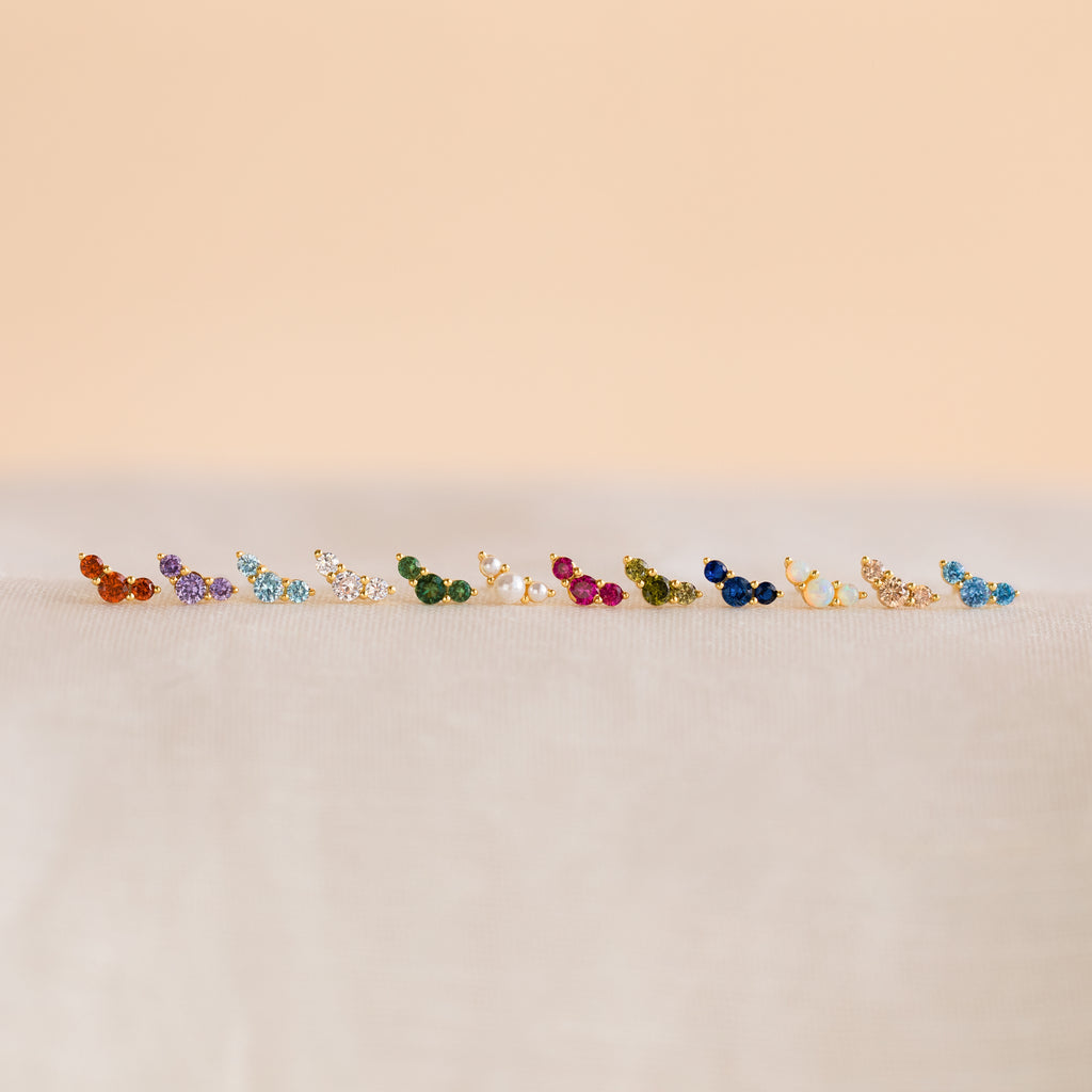 Bella Birthstone Studs—small, colorful studs displayed on a soft, neutral surface—make the perfect personalized jewelry gift for mothers and daughters.