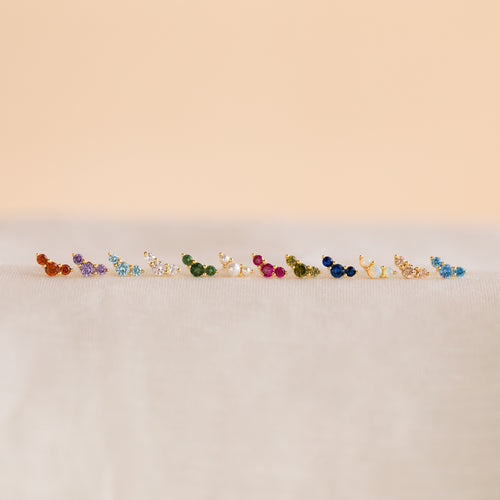 Bella Birthstone Studs—small, colorful studs displayed on a soft, neutral surface—make the perfect personalized jewelry gift for mothers and daughters.