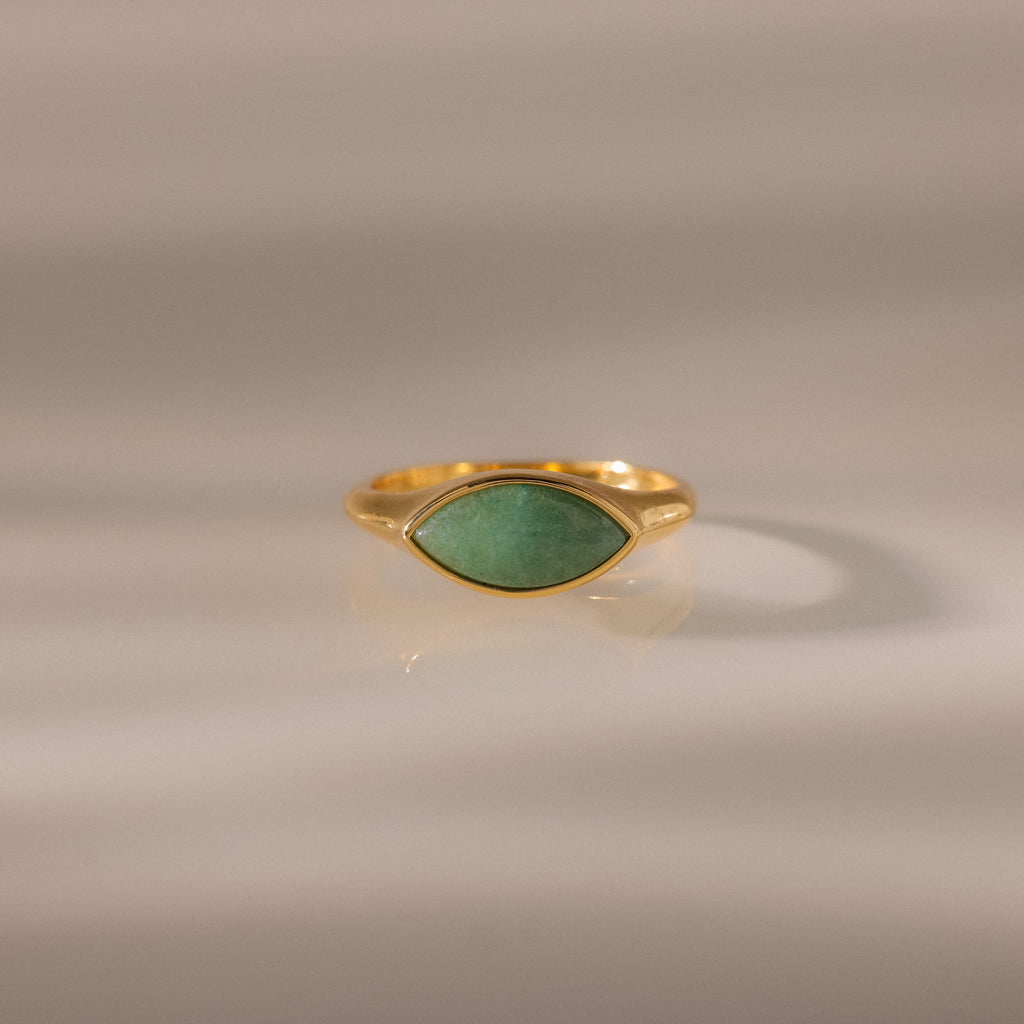 Marquise Jade Signet Ring with a marquise-shaped green jade stone shown on a neutral, softly lit background.