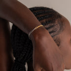 A woman wearing a Mixed Metal Knot Bracelet.