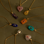 Eight Topaz Crystal Necklaces with bezel-set pendants are displayed in a circular arrangement on an olive surface.