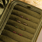 Inside Out Peridot Huggies are displayed in an olive green velvet jewelry case, perfect for pairing with gemstone earrings or stacking for a vibrant, personalized look.