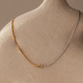 Love Knot Chain Necklace in Mixed Metal displayed on a neutral textured mannequin bust.