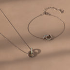 Interlocking Opal Inlay Necklace and Bracelet Set with elegant jewelry pendants displayed on a beige background.